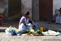 This woman has corn and spinach to sell at the food markets in La Paz - Mercado Rodriguez. Bolivia, South America.