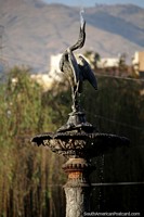 Larger version of A bird fountain sprays water up into the air at Plaza Colon in Cochabamba.