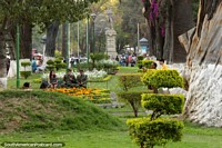 Long green park in central Cochabamba, a distant Simon Bolivar statue. Bolivia, South America.
