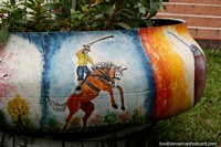 Man riding a horse, art painted on to a plant pot in the plaza in Bermejo. Bolivia, South America.