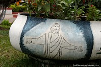 Jesus with outstretched arms, painted on to a plant pot in the plaza in Bermejo. Bolivia, South America.