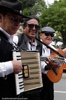Musicians play at the Sucre Carnival, guitars and accordion, black and white clothes. Bolivia, South America.