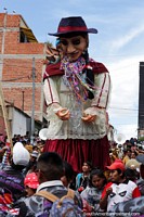 Huge boneco gets carried through the crowd at the Sucre carnival. Bolivia, South America.