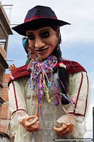 High above the crowds, a huge boneco as they call them in Brazil, carnival in Sucre. Bolivia, South America.