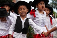Rapaz jovem com chapéu preto e terno preto e branco no carnaval de Sucre. Bolívia, América do Sul.