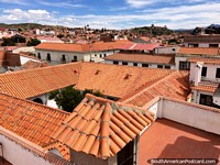 Red tiled roofs and white buildings and houses for as far as the eye can see in Sucre. Bolivia, South America.
