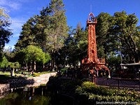 Central area of Bolivar Park with Eiffel tower, pond and towering trees in Sucre. Bolivia, South America.