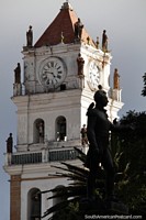 Cathedral tower with many small gold figures and the main statue from the center of the plaza in Sucre. Bolivia, South America.