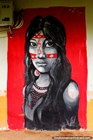 Indigenous woman with face paint a necklace of beads, street art in Cobija. Bolivia, South America.