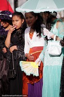 Ladies of Potosi, with nice dresses, umbrellas and fans, a special occasion. Bolivia, South America.