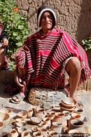 Larger version of Indigenous man from Puka-Puka makes ceramic pots, bowls and urns, a traditional shawl.