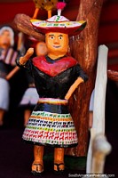 Crafts made from wood in Puka-Puka, a small indigenous figure with llamas on her dress. Bolivia, South America.