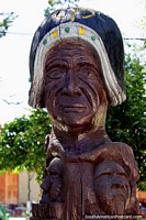 Wooden sculpture of a large face with 2 below at the plaza in Tarabuco. Bolivia, South America.
