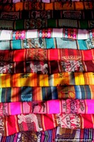 A range of colored shawls to carry goods or your baby around in, Tarabuco market. Bolivia, South America.