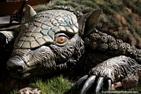 A scary but cute creature with sharp claws, covered in grass in the gardens of the main square in Oruro. Bolivia, South America.