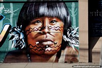 With wood through his nose and mouth, an indigenous man, work of street art in Cochabamba.