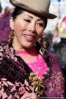 Hermosa dama de sombrero vestida de rosa y morado disfrutando del desfile de El Gran Poder en La Paz. Bolivia, Sudamerica.