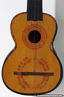 An antique guitar with red and green patterns on display at the textile arts museum (Cetur) in Sucre. Bolivia, South America.