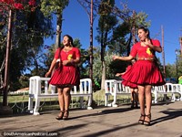 Ladies in red, dancers perform at Bolivar Park, a beautiful place in Sucre, big smiles.