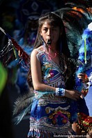 Beautiful young lady in fantastic traditional dress blows a whistle at the El Gran Poder parade in Sucre. Bolivia, South America.