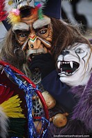 Masked man with a white saber-toothed tiger, traditional costume and mask at El Gran Poder parade in Sucre. Bolivia, South America.