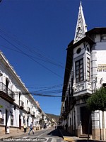 White tower and buildings on the corner of the main plaza in Sucre.