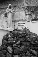 Larger version of Praying Maria monument beside rocks in Yacuiba.