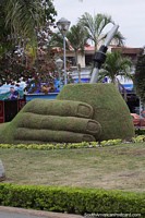 Large grassy monument of a hand holding a cup of Mate tea in Yacuiba. Bolivia, South America.
