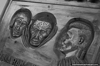 Sculptured wood carvings with 3 faces on the facade of a hotel and restaurant in San Jose de Chiquitos.