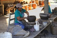 Lady sculpts and molds clay into the shape of a pot by hand in San Ignacio de Velasco.