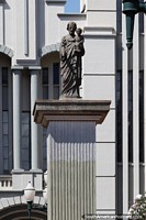 Man holding child, statue in front of the cathedral in Campo Mourao.