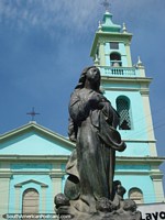 Statue in front of a green church in Corumba. Brazil, South America.