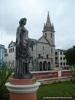 Statue in gardens of Teatro Amazonas with church Igreja de Sao Sebastiao behind, Manaus. Brazil, South America.