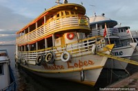 Larger version of A yellow ferry glows a little as the sun goes down in Santarem.
