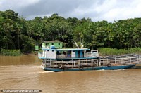 An empty animal transport ferry cruises the Parauau River north of Breves. Brazil, South America.