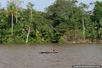 Mother and son in a canoe in the Amazon south of Macapa. Brazil, South America.