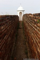Brick walls and a narrow corridor leading to a bastion at the fort in Macapa.