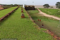 Boys play soccer below the fortress beside the Amazon River in Macapa. Brazil, South America.