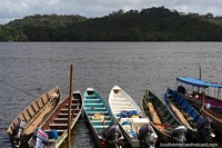 Moored boats in Oiapoque point towards the riverbanks of French Guiana. Brazil, South America.