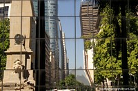 Buildings and monument in Rio de Janeiro reflected in the windows of a modern building. Brazil, South America.