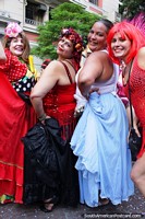 4 women in colorful fancy dress pose for a picture at carnival activities in Sao Paulo.