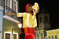 Larger version of Carnival is coming in Salvador, the muneco puppets tower from above.