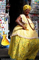 The African culture in Salvador is evident, woman in yellow and a painting also. Brazil, South America.