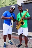 Saxophone and trumpet players dressed in green and blue, carnival time in Salvador.