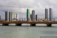 A river, a bridge and tall buildings in Recife. Brazil, South America.