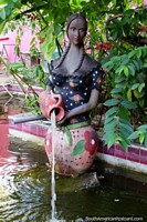 Ceramic woman pours water, gardens and water feature in Olinda. Brazil, South America.