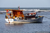 Fishing boat moored close to shore at Pipa Beach. Brazil, South America.