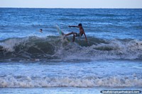 Un surfista joven en las olas en la playa de Ponta Negra en Natal. Brasil, Sudamerica.