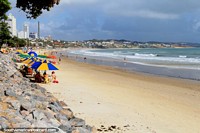 Looking north along Ponta Negra Beach, white sands and bright umbrellas, Natal.