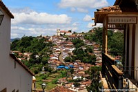 View over tiled roofs to the hilltop and the Church of Santa Efigenia in Ouro Preto. Brazil, South America.